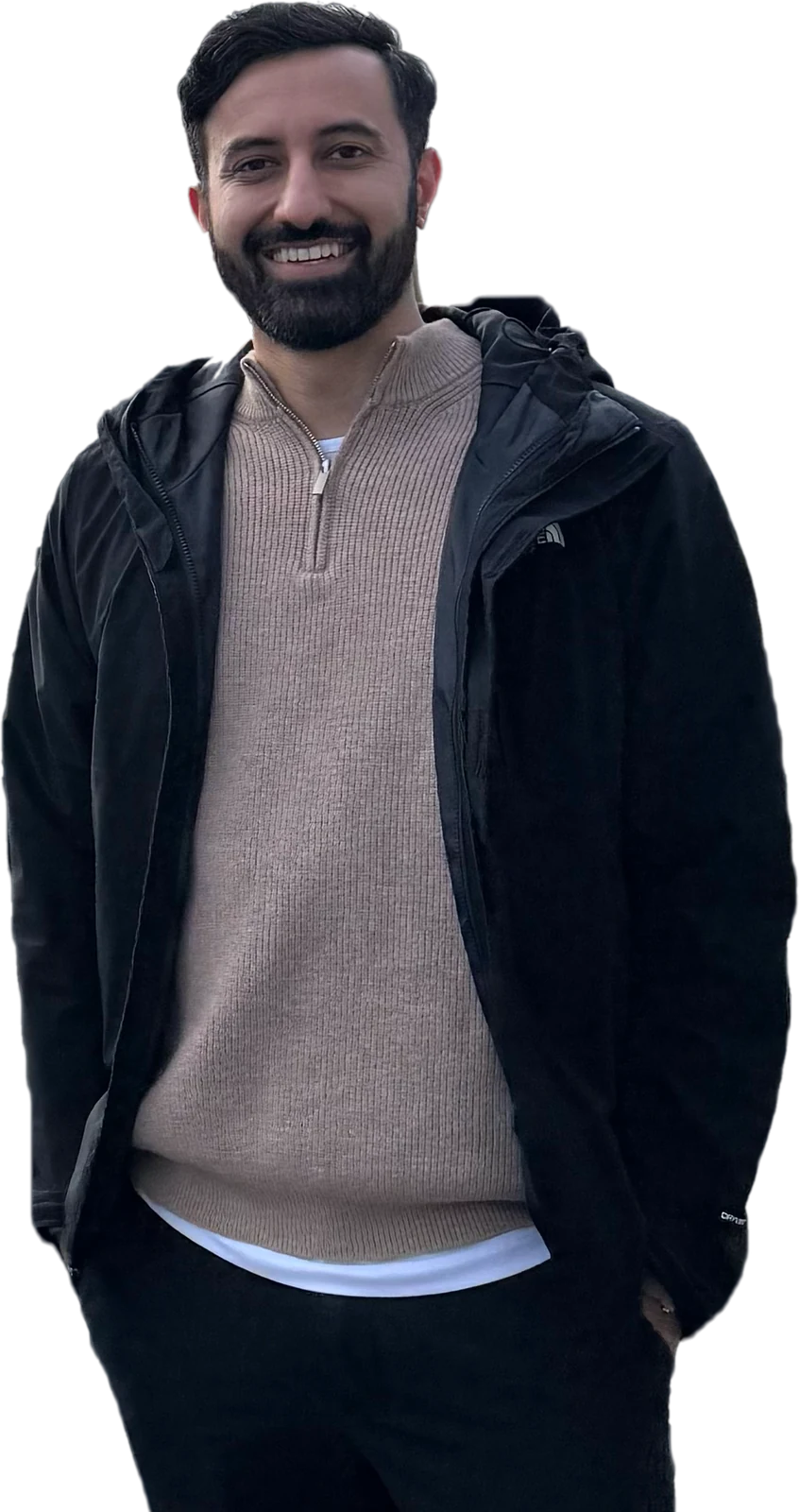 Anisur Khan smiling, in a black jacket and tan quarter-zip sweater